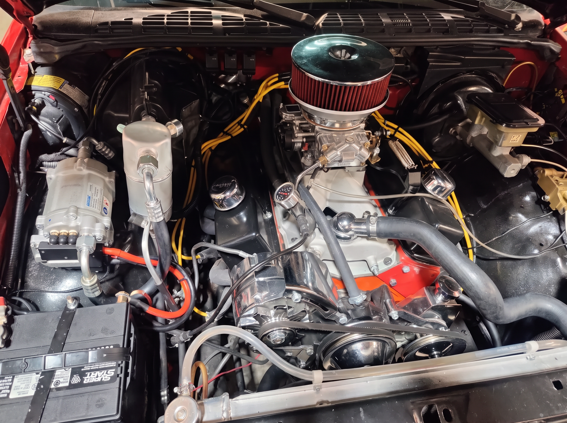 Detailed carbureted V8 engine bay with chrome air cleaner